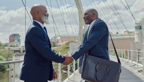 Two professionals shaking hands in greeting